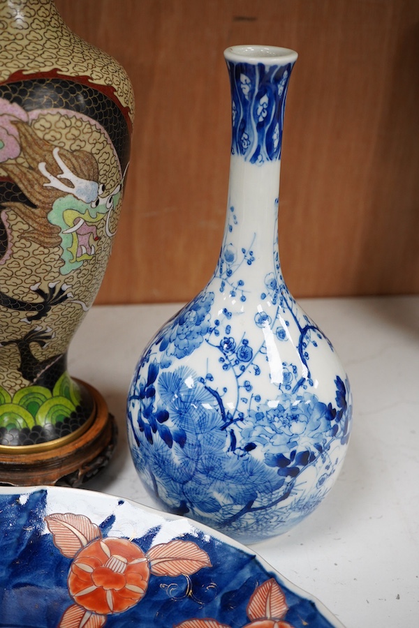 A Japanese Imari dish an Arita bottle vase together with a Chinese cloisonné enamel vase and a Chinese hardstone boulder carving, largest 34cm in diameter